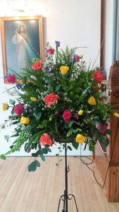 Pedestal with bright roses and tulips